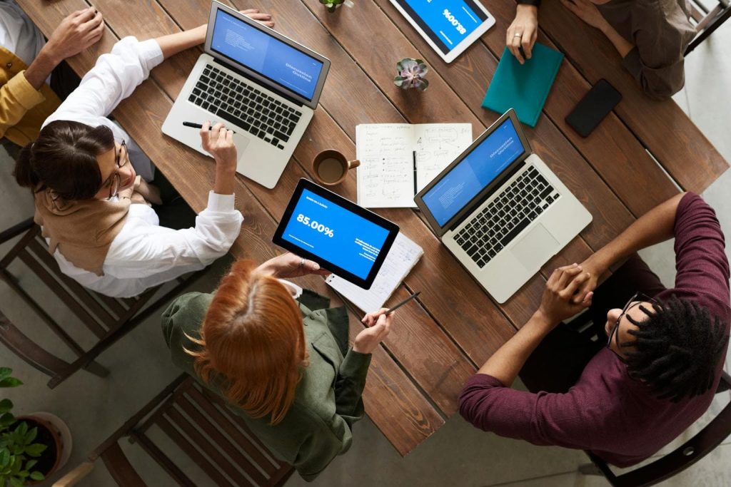 top-view-photo-of-group-of-people-using-macbook